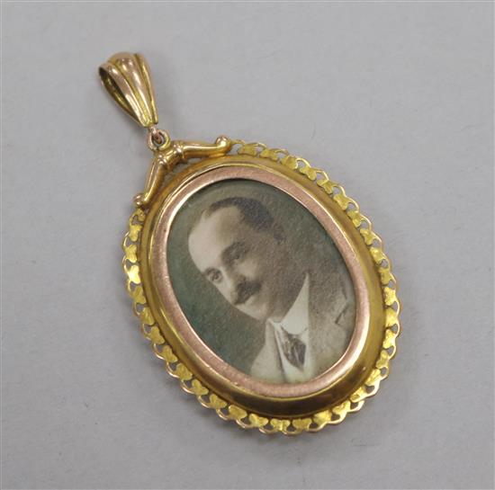 A yellow metal oval portrait pendant, 36mm.